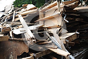 Debris and wooden remains and garbage pile on a stack on demolition site of a building