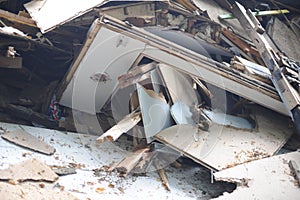 Debris and wooden remains and garbage pile on a stack on demolition site of a building