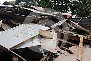 Debris and wooden remains and garbage pile on a stack on demolition site of a building