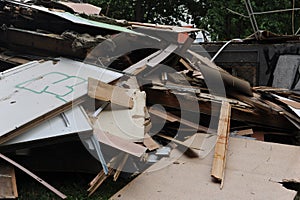 Debris and wooden remains and garbage pile on a stack on demolition site of a building