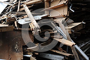 Debris and wooden remains and garbage pile on a stack on demolition site of a building