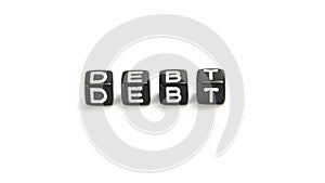 Debt - Business Vocabulary Word on Black Dice isolated on white background.