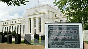 A debt clock and the exterior of the federal reserve building