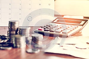 Debt collection and tax season concept with deadline calendar remind note,coins,banks,calculator on table