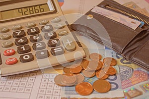 Debt collection and tax season concept with deadline calendar remind note, coins, calculator on table, background, time to pay