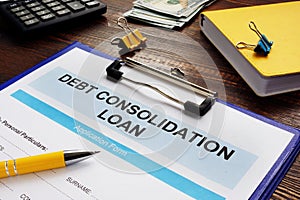 Debt consolidation loan, notepad and calculator.