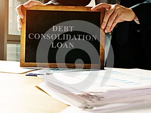 Debt consolidation loan sign and pile of papers