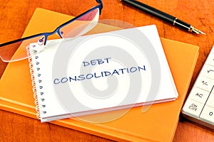 Debt consolidation. This is the process of obtaining a new loan to repay a number of existing debts. The text is written on a