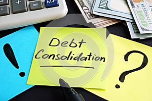 Debt consolidation written by hand and money.