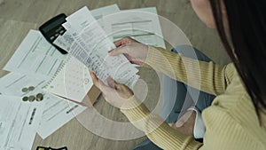 Debt and financial problems concept. woman is sitting on the floor and tension on invoices and credit card debt. woman are stresse