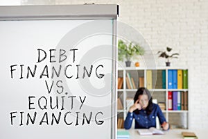 Debt financing vs equity financing words on whiteboard.