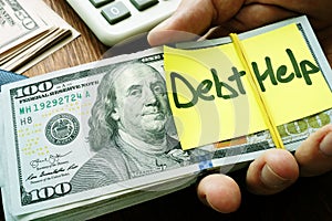 Debt help concept. Hand holding stack of money