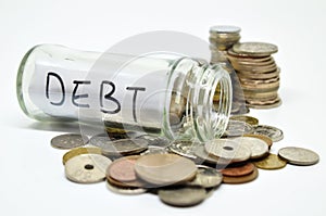Debt lable in a glass jar with coins spilling out