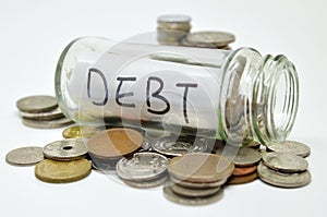 Debt lable in a glass jar with coins spilling out