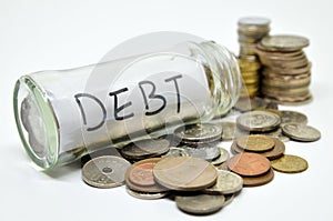 Debt lable in a glass jar with coins spilling out