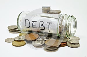 Debt lable in a glass jar with coins spilling out