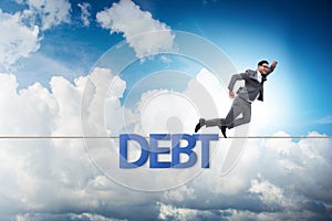 Debt and loan concept with businessman walking on tight rope