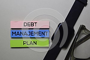 Debt Manajement Plan - DMP text on sticky notes isolated on office desk