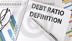 Debt Ratio Definition text on notebook on chart background