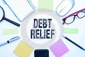 DEBT RELIEF text surrounded by school and office supplies