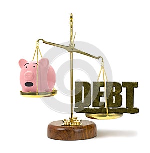 DEBT on a scale outweighing worried piggy bank representing financial problems