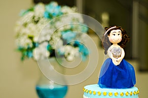 Debutante doll on the cake.