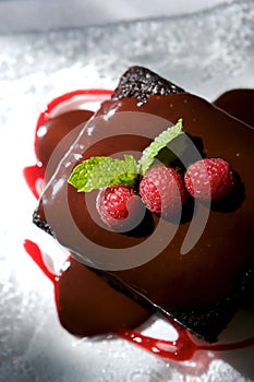 Decadent chocolate cake with raspberries photo