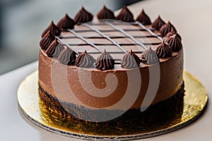 Decadent chocolate cake with swirls of chocolate frosting photo