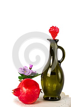 A decanter on a background of pomegranate on a white background