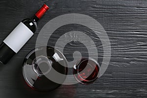 Decanter, glass and bottle with red wine