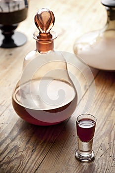 Decanter with glass of liqueur.