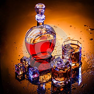 Decanter and two glasses with whisky and ice