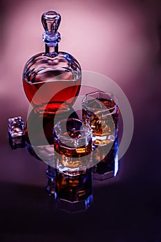 Decanter and two glasses with whisky and ice