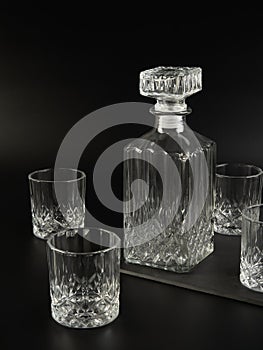 Decanter and whiskey glasses on a dark background