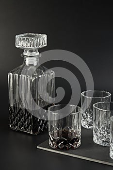 Decanter and whiskey glasses on a dark background