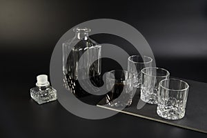 Decanter and whiskey glasses on a dark background