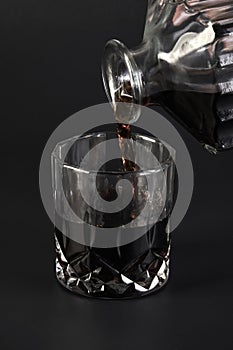 Decanter and whiskey glasses on a dark background