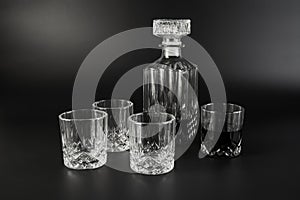 Decanter and whiskey glasses on a dark background