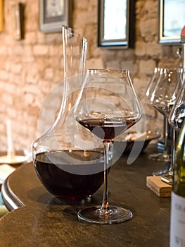 Decanting old wine. Red wine in a glass on the bar