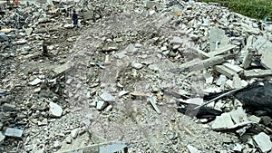 Decayed concrete from a collapsed building Lots of cement debris piled up on the floor.