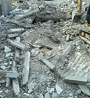 Decayed concrete from a collapsed building Lots of cement debris piled up on the floor.