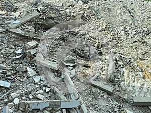 Decayed concrete from a collapsed building Lots of cement debris piled up on the floor.