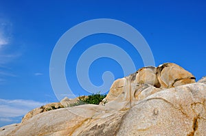 Decayed granite under blue sky