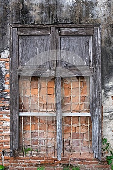 Decayed window and wall texture.