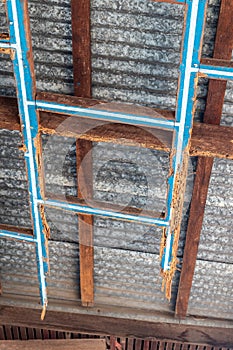 A decayed wood structure under the zinc roof of a house