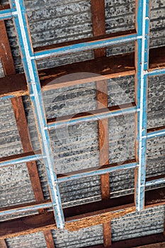 A decayed wood structure under the zinc roof of a house