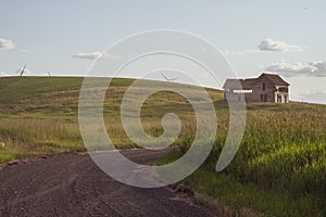 Decaying, abandoned spooky old farmhouse shack in the rolling hills of the Palouse region of Washington State