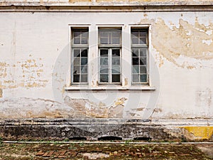 Decaying glazed windows of an abandoned building.