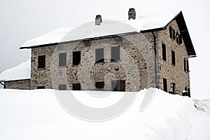 Decaying house, winter in Dolomiti mountains, in Cadore, Italy