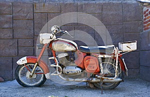 decaying old unused red motorcycle